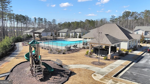 view of pool with a gazebo and a playground