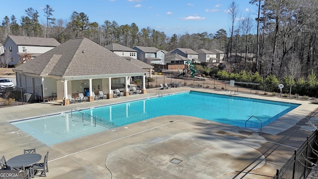 view of swimming pool with a playground and a patio