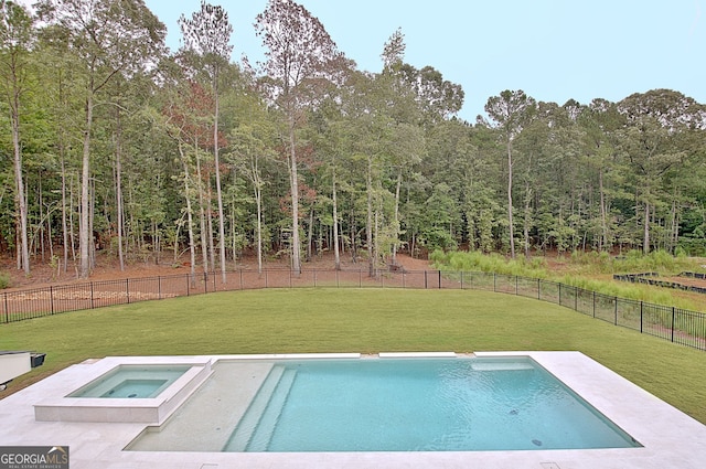 view of swimming pool featuring an in ground hot tub and a lawn