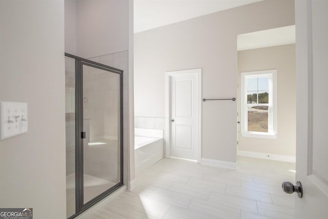 bathroom with separate shower and tub