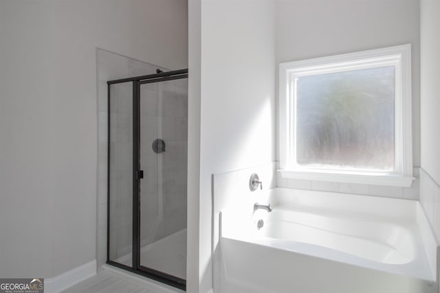 bathroom with separate shower and tub