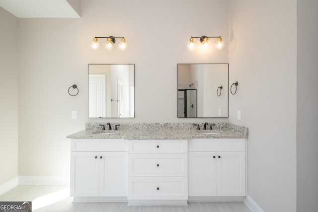 bathroom with vanity and a shower with shower door