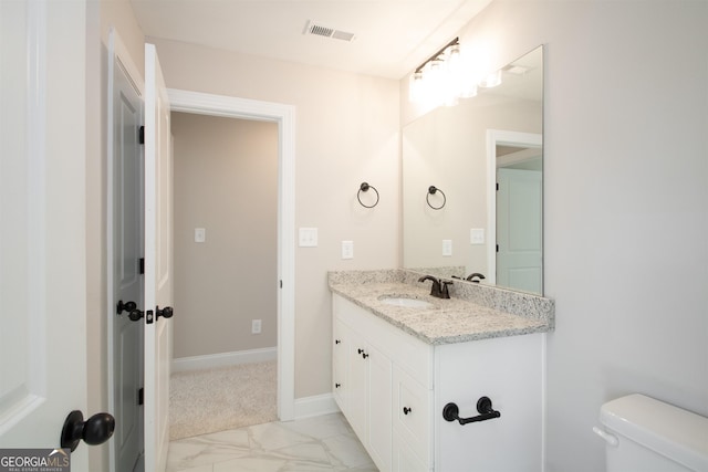 bathroom with vanity and toilet