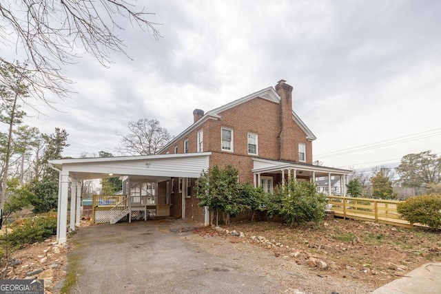 exterior space with a carport and a porch