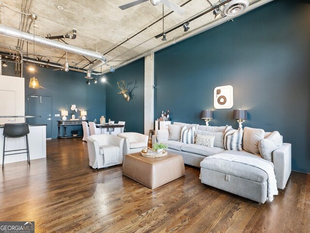 living room with ceiling fan, dark hardwood / wood-style flooring, and rail lighting