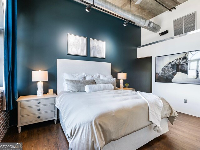 bedroom with dark hardwood / wood-style flooring