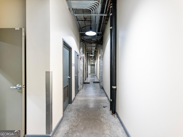 hall featuring concrete flooring