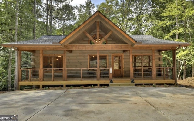 rear view of property featuring covered porch