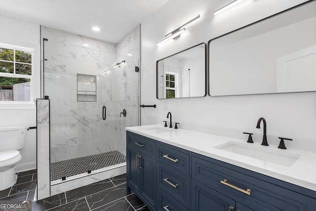 bathroom featuring vanity, toilet, and a shower with shower door