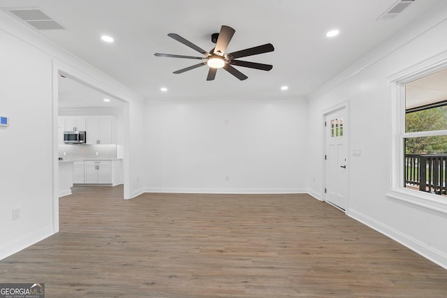 spare room with ornamental molding, dark hardwood / wood-style floors, and ceiling fan