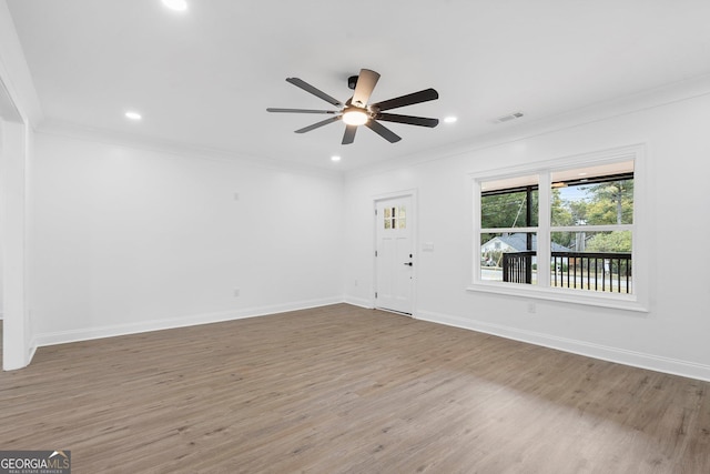 spare room featuring ornamental molding, hardwood / wood-style floors, and ceiling fan