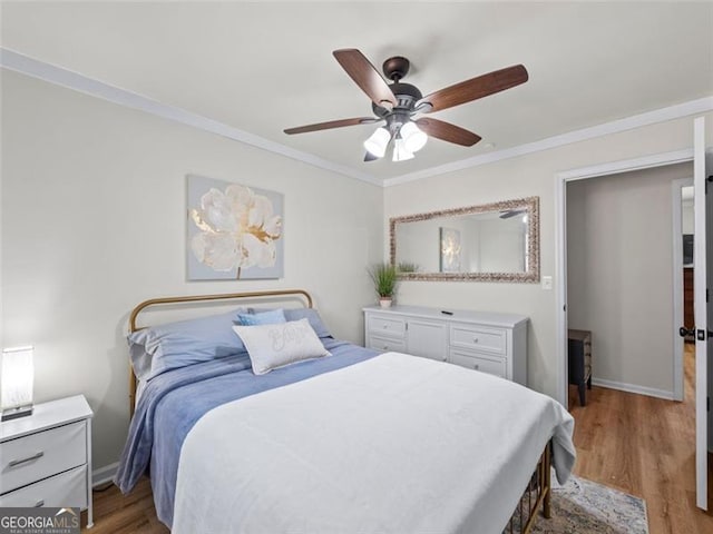 bedroom with crown molding, ceiling fan, and hardwood / wood-style flooring