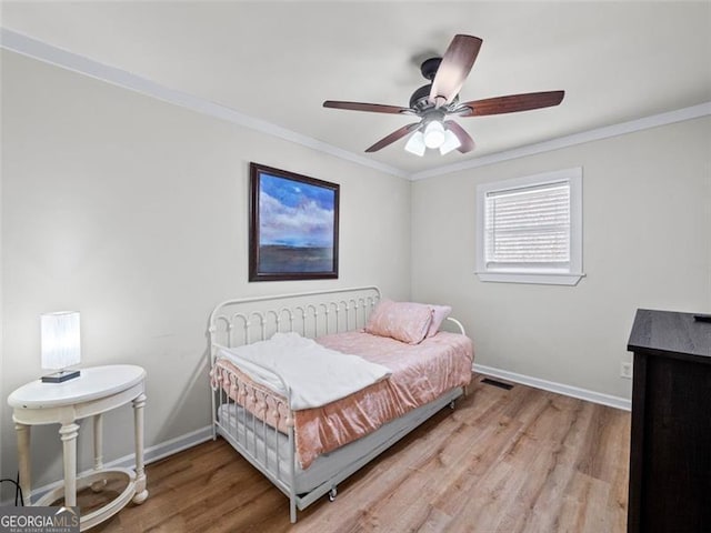 bedroom featuring crown molding, wood-type flooring, and ceiling fan