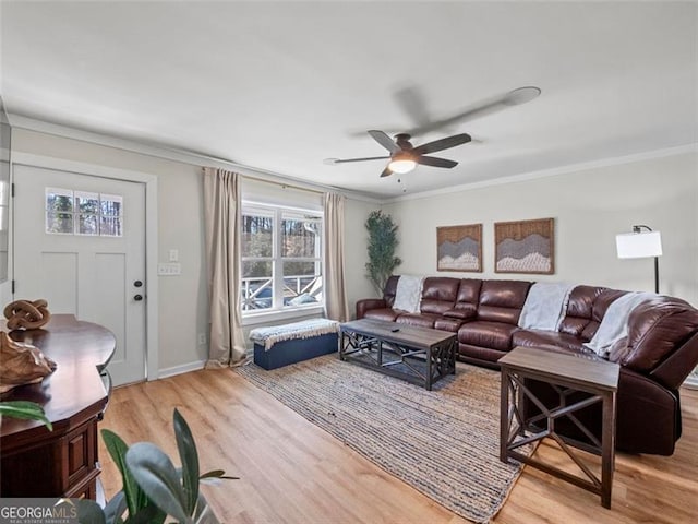 living room featuring crown molding, ceiling fan, and light wood-type flooring