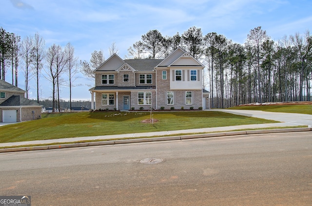 view of front facade featuring brick siding and a front yard