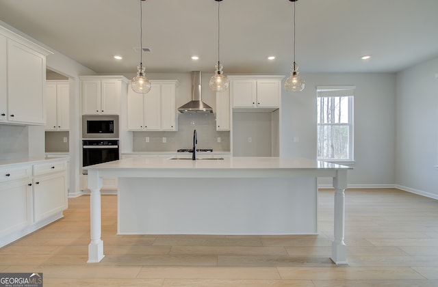 kitchen featuring stainless steel microwave, visible vents, oven, wall chimney range hood, and light countertops