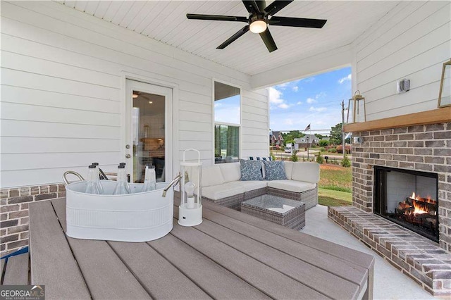 view of patio with an outdoor living space with a fireplace