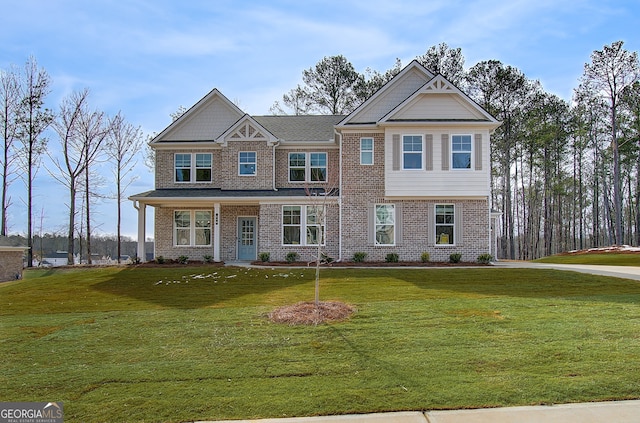 view of front of home with a front yard and brick siding