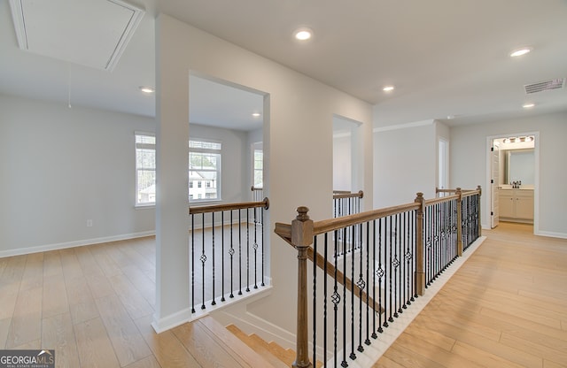 corridor featuring visible vents, attic access, an upstairs landing, recessed lighting, and wood finished floors