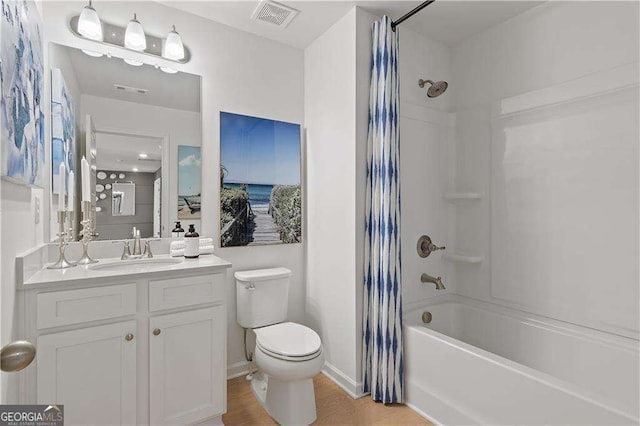 full bathroom featuring vanity, toilet, and shower / tub combo