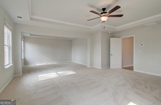 unfurnished bedroom featuring visible vents, a raised ceiling, and baseboards