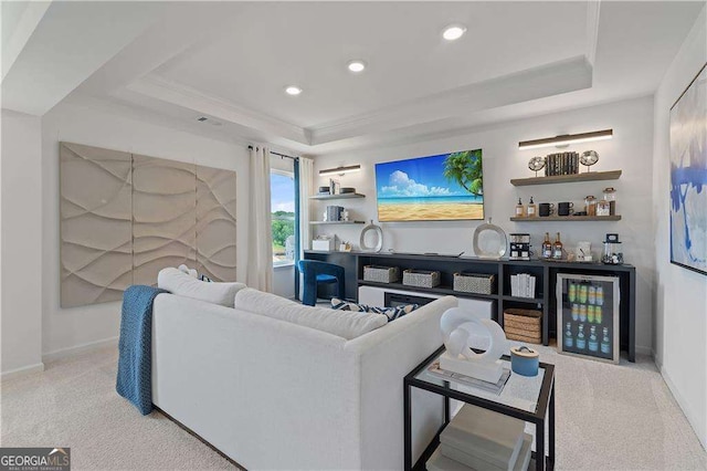 carpeted living room with a raised ceiling, ornamental molding, and indoor bar