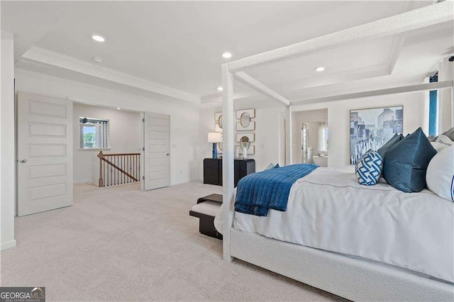 carpeted bedroom featuring ornamental molding and a tray ceiling