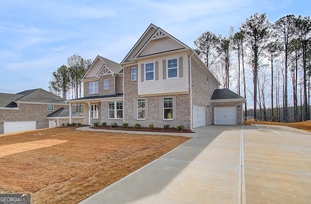 view of front facade featuring a garage, brick siding, and driveway