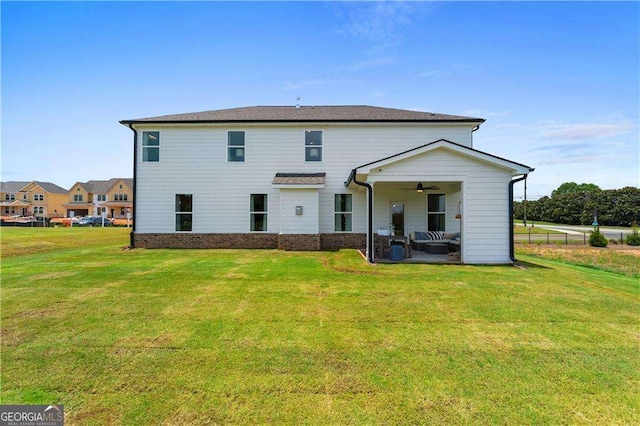 back of house with a lawn, ceiling fan, and a patio area