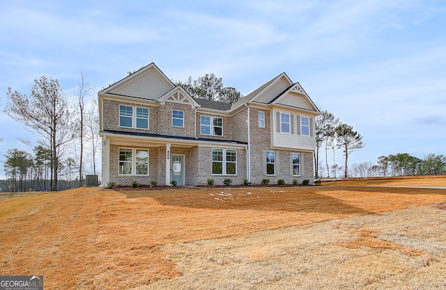 craftsman-style house featuring cooling unit and brick siding