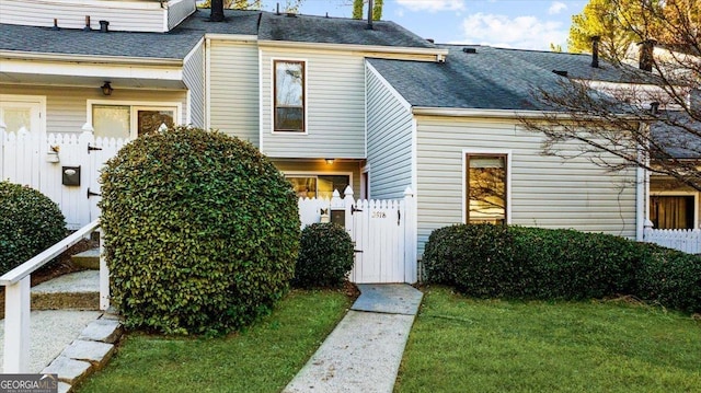 doorway to property with a lawn