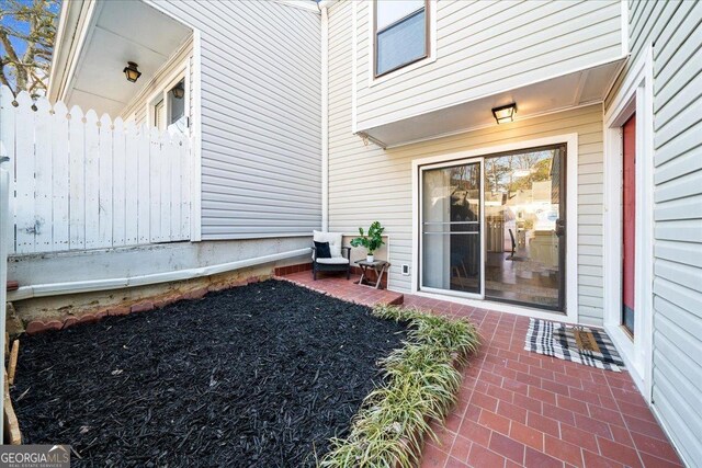 view of exterior entry featuring a patio