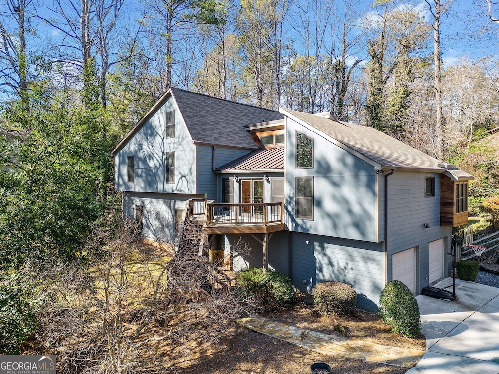 view of front of property with a wooden deck and a garage