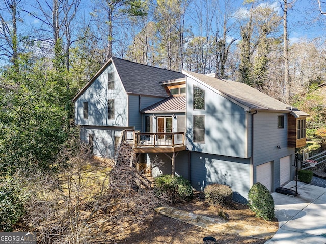 view of front of property with a wooden deck and a garage