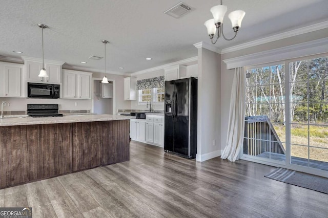 kitchen featuring white cabinetry, pendant lighting, light stone counters, and black appliances