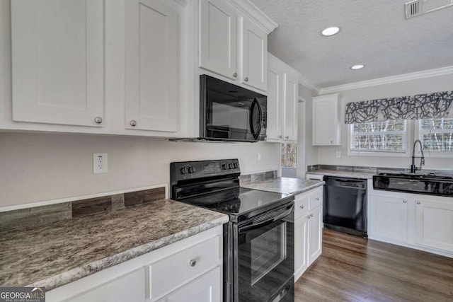 kitchen featuring sink, white cabinetry, ornamental molding, black appliances, and a textured ceiling