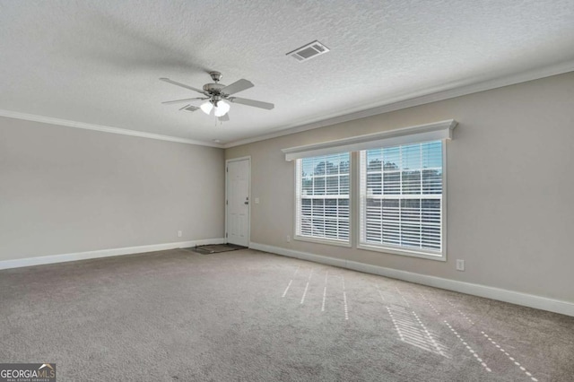 carpeted spare room with ceiling fan, ornamental molding, and a textured ceiling