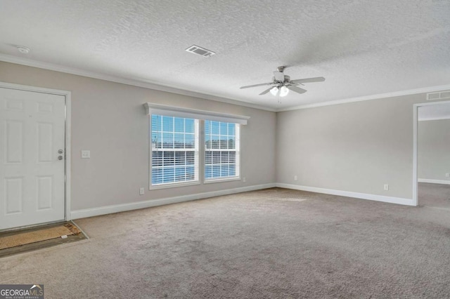 interior space with ornamental molding, carpet flooring, a textured ceiling, and ceiling fan