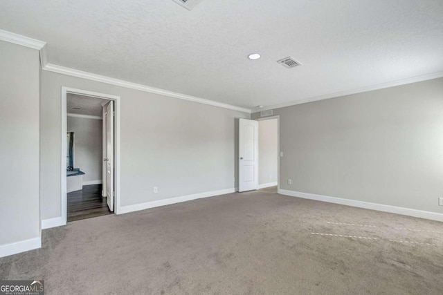 empty room with crown molding, dark carpet, and a textured ceiling