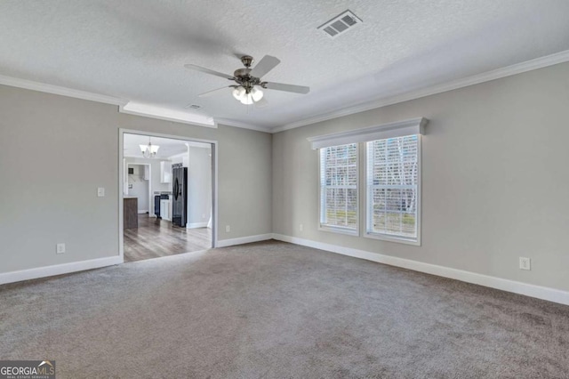 carpeted empty room featuring ornamental molding, ceiling fan with notable chandelier, and a textured ceiling