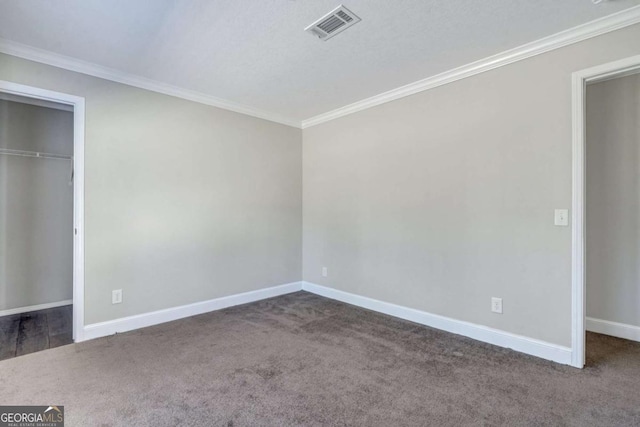 unfurnished bedroom featuring ornamental molding, a closet, and dark colored carpet