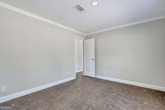 empty room featuring ornamental molding, carpet floors, and a textured ceiling