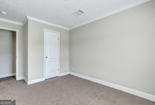 unfurnished bedroom featuring ornamental molding, light carpet, and a textured ceiling