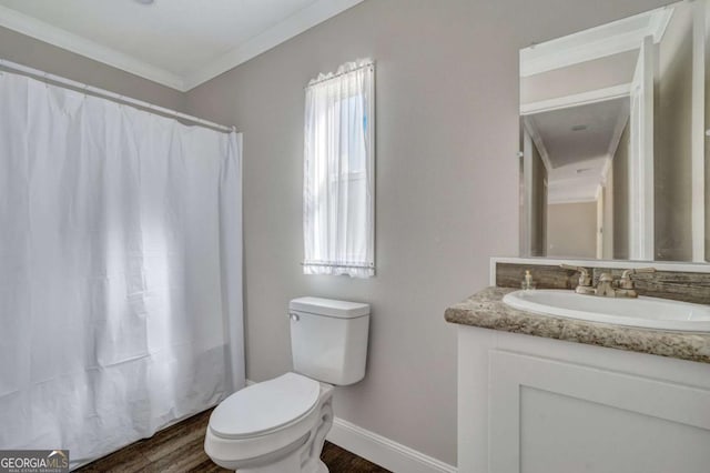 bathroom featuring ornamental molding, vanity, toilet, and hardwood / wood-style floors