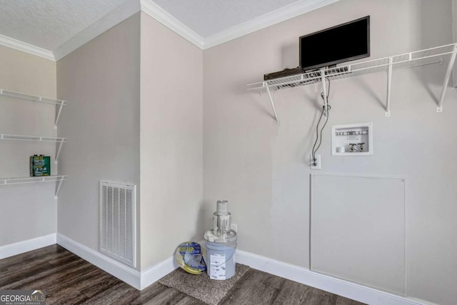 laundry area featuring dark wood-type flooring, washer hookup, crown molding, and a textured ceiling