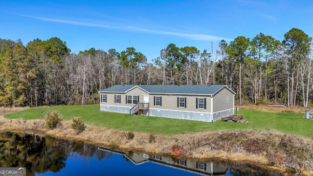 view of front of house with a water view and a front lawn