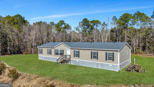 rear view of house with a lawn