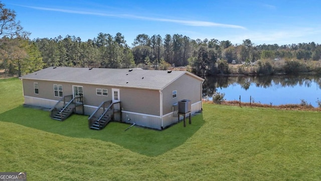 rear view of house with a water view, central AC, and a lawn