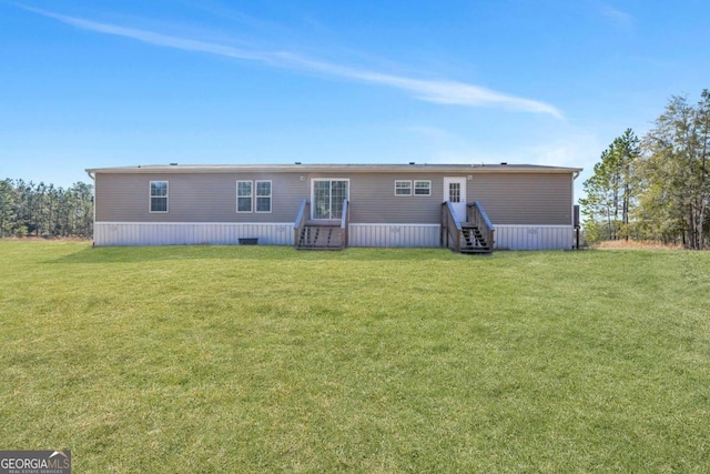 rear view of house with a lawn