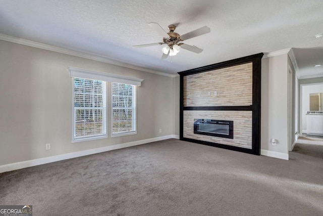 unfurnished living room with a fireplace, carpet flooring, ceiling fan, crown molding, and a textured ceiling